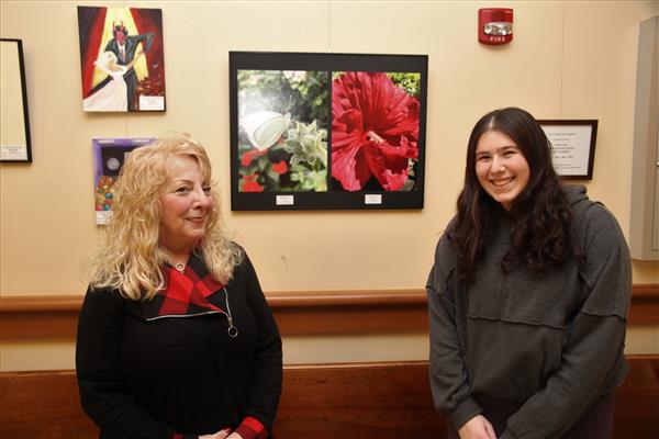 teacher and student pose with art